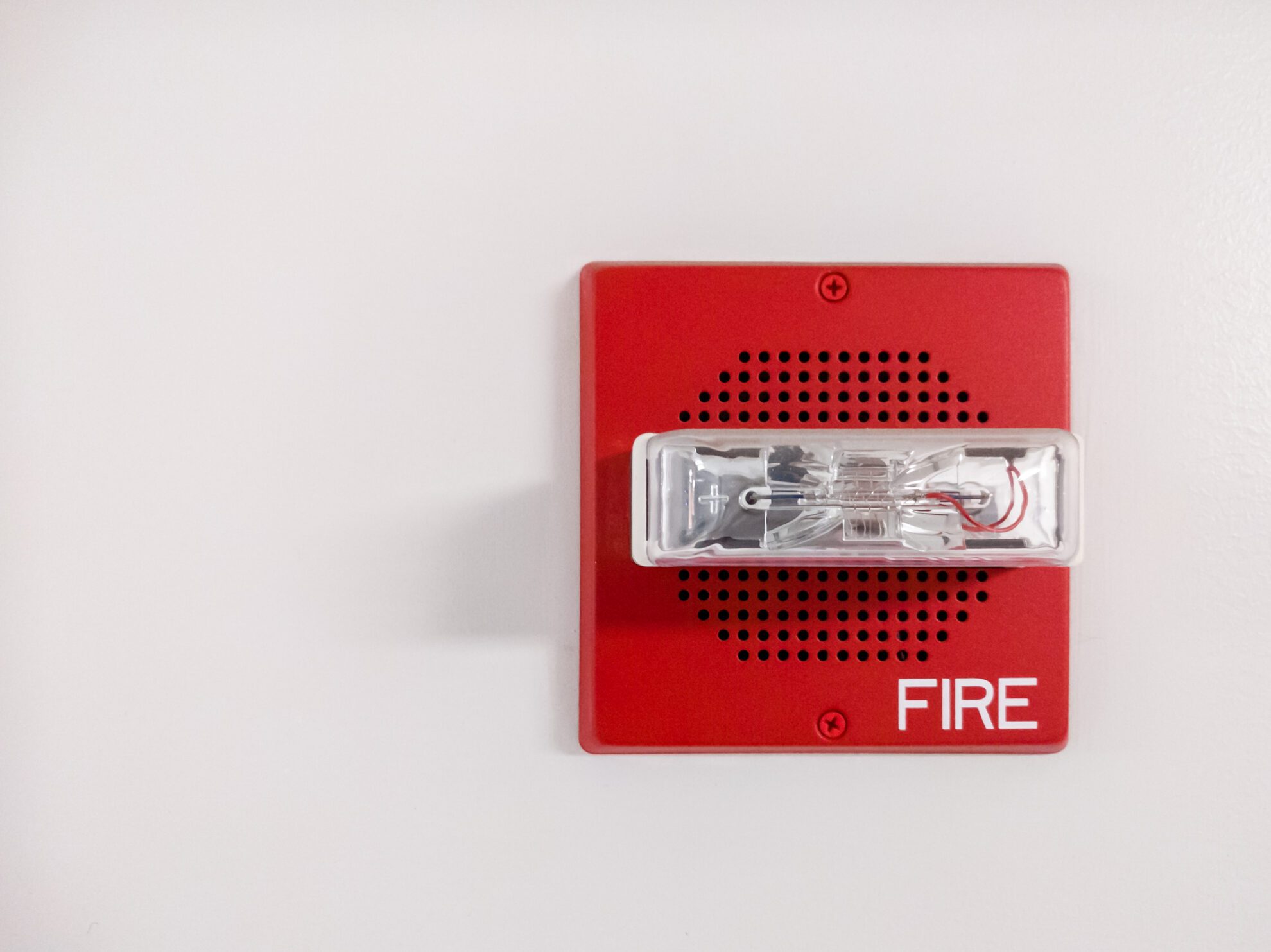 Close-up of a red accessible audio visual fire alarm
