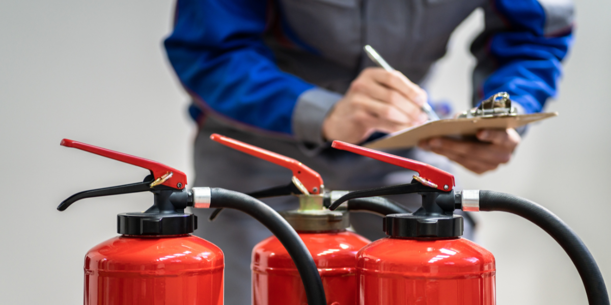 Two fire extinguishing cylinders used in commercial fire suppression systems